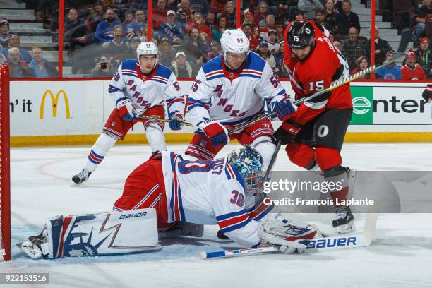 Zack Smith of the Ottawa Senators battles for the puck against Nick Holden of the New York Rangers as Henrik Lundqvist makes a save at Canadian Tire...