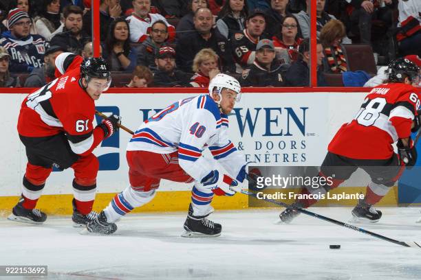 Michael Grabner of the New York Rangers skates with the puck against Mark Stone of the Ottawa Senators at Canadian Tire Centre on February 17, 2018...