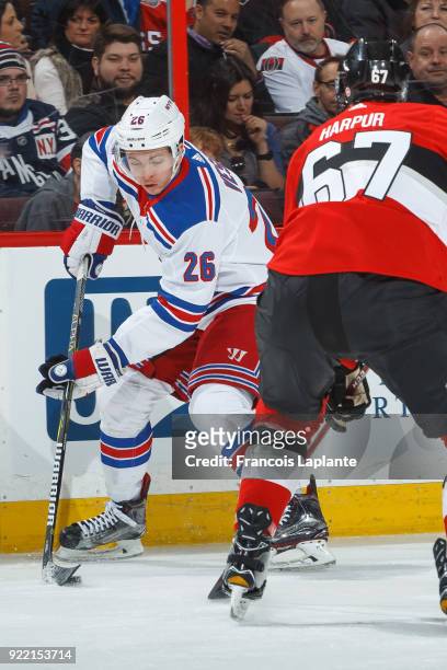 Jimmy Vesey of the New York Rangers controls the puck against Ben Harpur of the Ottawa Senators at Canadian Tire Centre on February 17, 2018 in...