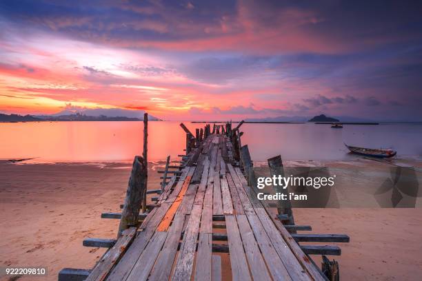 jetty black sand beach (fisherman vilage) in langkawi island, malaysia. - langkawi stock-fotos und bilder