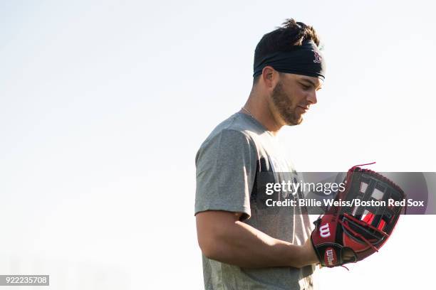 Andrew Benintendi of the Boston Red Sox holds a Wilson glove during a team workout on February 21, 2018 at jetBlue Park at Fenway South in Fort...