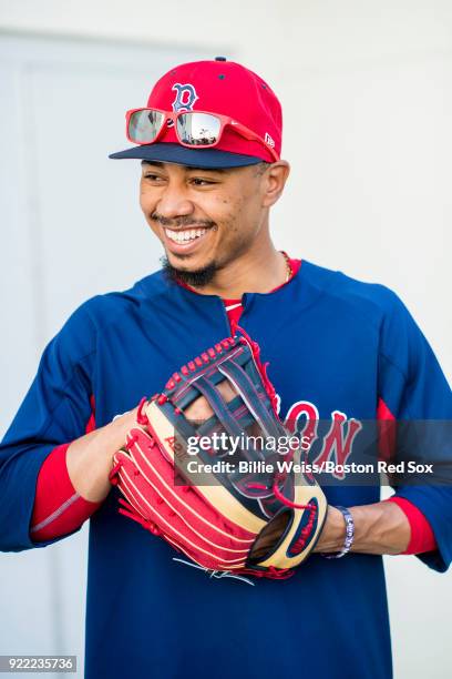 Mookie Betts of the Boston Red Sox reacts as he holds a Wilson glove during a team workout on February 21, 2018 at jetBlue Park at Fenway South in...