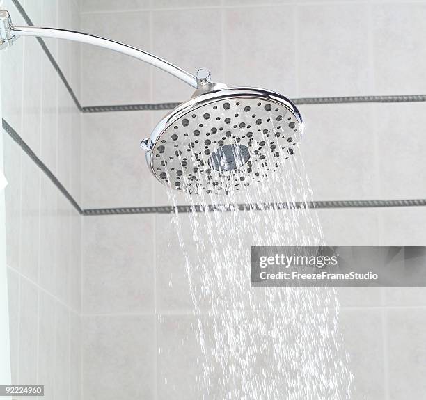 overhead rainfall showerhead installed in ceramic tile shower - shower head stock pictures, royalty-free photos & images