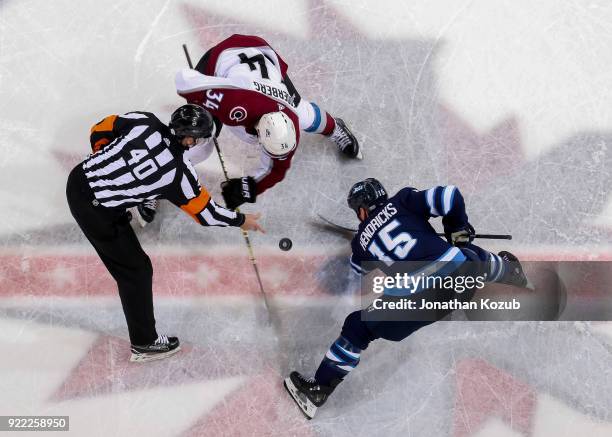 Carl Soderberg of the Colorado Avalanche and Matt Hendricks of the Winnipeg Jets take a third period face-off at the Bell MTS Place on February 16,...