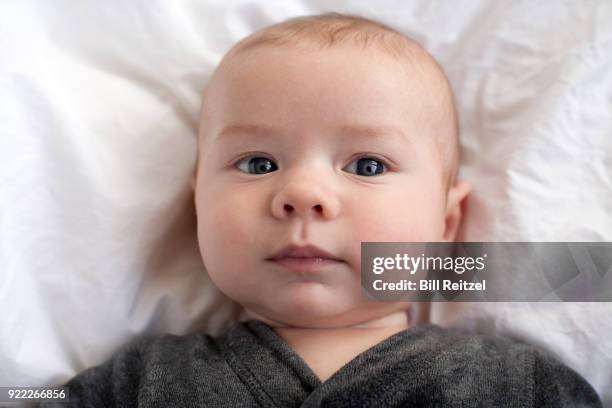 1 boy lying down on bed - corte madera stock pictures, royalty-free photos & images