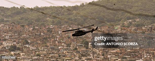 Police helicopter overflies Alemao complex shantytown in Rio de Janiero, during a police operation on October 22, 2009. The number of deaths from a...