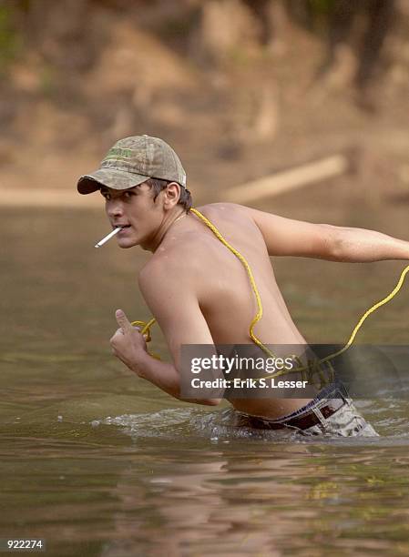 Participant in the Oconee River Raft Race pulls a raft down the river during the Seventh Annual Summer Redneck Games July 6, 2002 in East Dublin,...