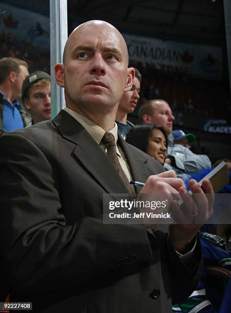 Assistant coach Darryl Williams of the Vancouver Canucks looks on from the bench during their game against the Dallas Stars at General Motors Place...