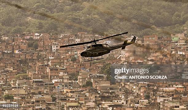 Police helicopter overflies Alemao complex shantytown in Rio de Janiero, during a police operation on October 22, 2009. The number of deaths from a...