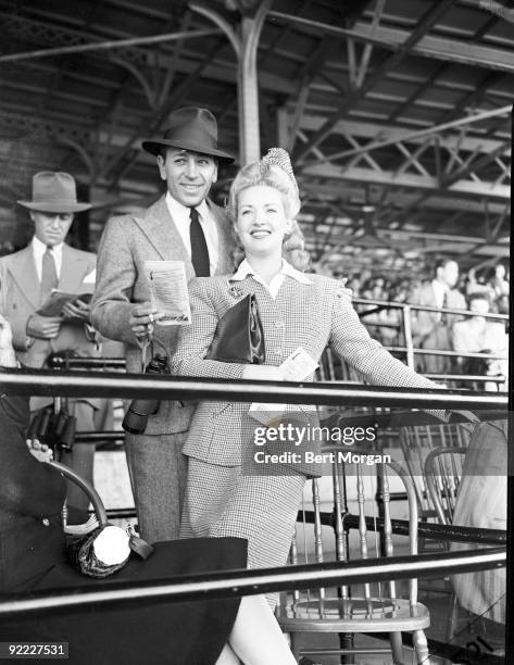 Actor George Raft and actress Betty Grable at Belmont Park Race Track, Elmont, NY, 1939.
