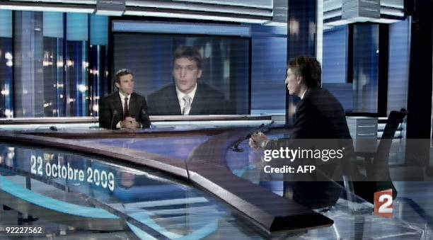 Tv grab taken from French TV channel France 2 shows elected councillor in Neuilly, Jean Sarkozy facing TV journalist David Pujadas during France 2...