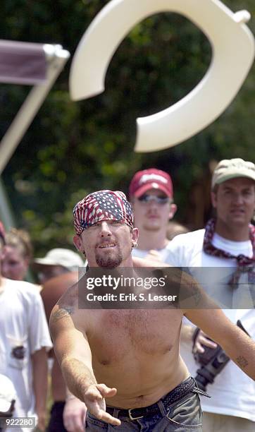 Johnny Sanders tosses a toilet seat in the Redneck Games version of horseshoes at the Seventh Annual Summer Redneck Games July 6, 2002 in East...