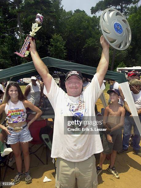 Eric Outler celebrates his victory in the hubcap hurl event at the Seventh Annual Summer Redneck Games July 6, 2002 in East Dublin, Georgia....