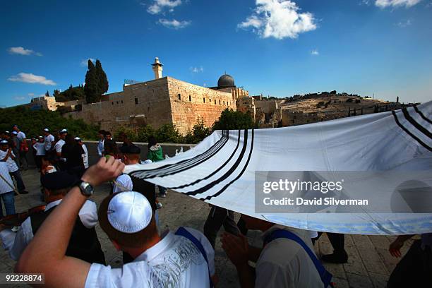 Religious Jewish family escorts their 13-year-old son under a Tallit past al-Aqsa mosque to his Barmitzvah ceremony at the Western Wall, Judaism's...