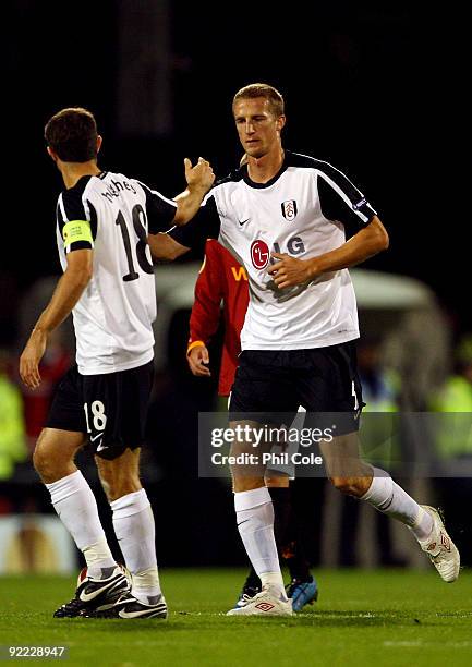 Brede Hangeland of Fulham celebrates with his team mate Aaron Hughes of Fulham after Hangeland scored the first goal during the Group E Europa League...