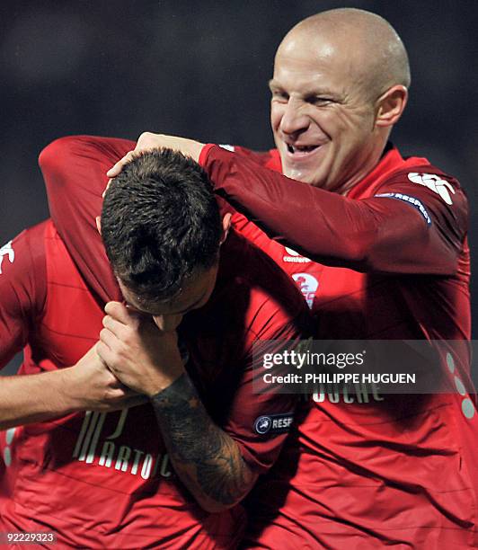 French-Polish Lille's midfielder Ludovic Obraniak is congratuled by teammate Florent Balmont after scoring a goal during their UEFA Europa League...