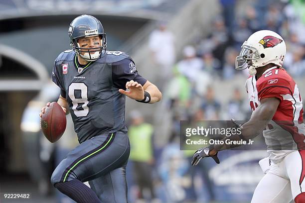Quarterback Matt Hasselbeck of the Seattle Seahawks moves to pass the ball against Antrel Rolle of the Arizona Cardinals on October 18, 2009 at Qwest...