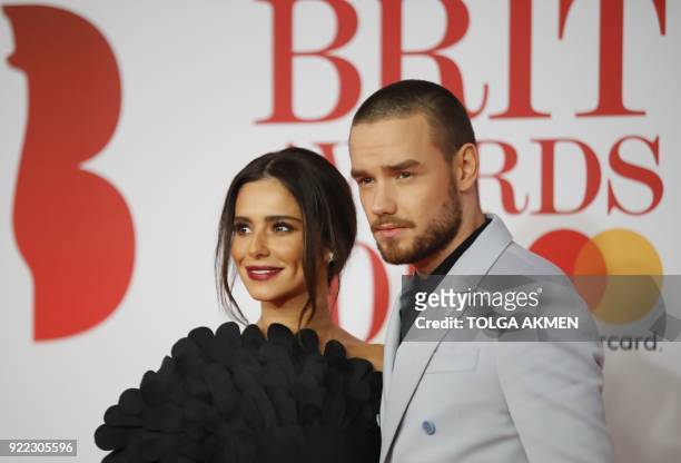 British singer-songwriter Liam Payne and partner Cheryl pose on the red carpet on arrival for the BRIT Awards 2018 in London on February 21, 2018. /...