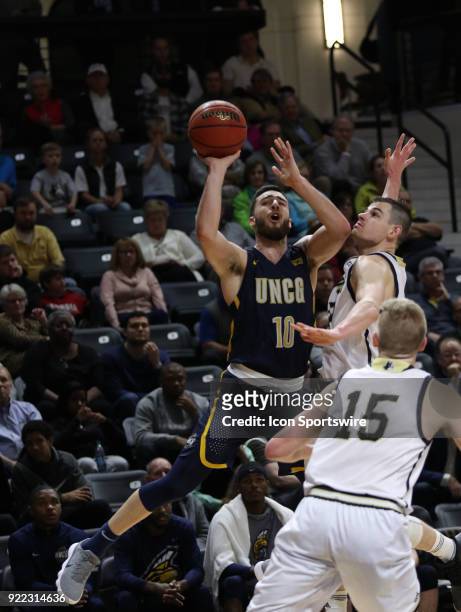 Francis Alonso UNC Greensboro looks to shoot the ball as Fletcher Magee guard Wofford College Terriers defends on the play, during action against...