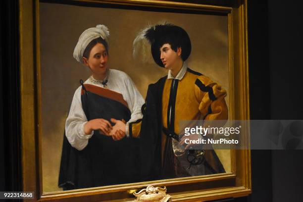 People are seen looking at the artwork La Buenaventura painted in oil on canvas by the Italian artist Caravaggio at the Exhibition 'Caravaggio an...