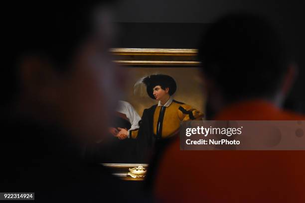 People are seen looking at the artwork La Buenaventura painted in oil on canvas by the Italian artist Caravaggio at the Exhibition 'Caravaggio an...