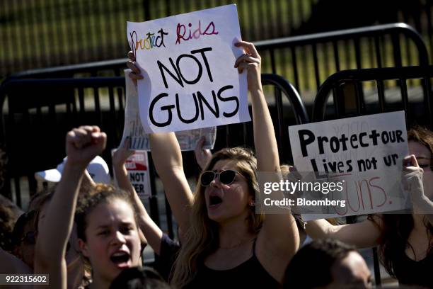 Demonstrator holds up a sign reading "Protect Kids, Not Guns" while protesting gun violence outside the White House in Washington, D.C., U.S., on...