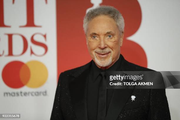 British singer Tom Jones poses on the red carpet on arrival for the BRIT Awards 2018 in London on February 21, 2018. / RESTRICTED TO EDITORIAL USE NO...