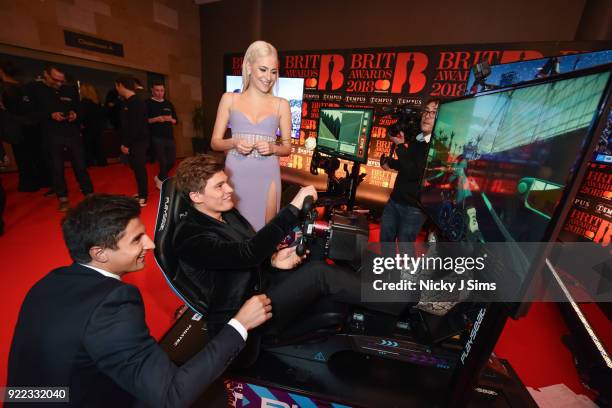 Oliver Cheshire tries to beat Panasonic Jaguar Racing Formula E driver Mitch Evans' lap time on Formula E simulators during The BRIT Awards 2018...