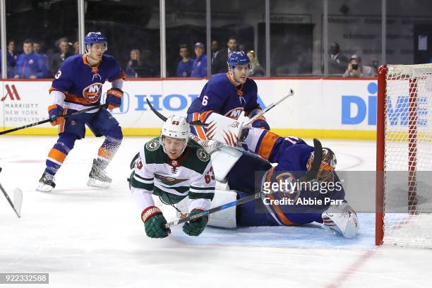 Tyler Ennis of the Minnesota Wild collides with Jaroslav Halak of the New York Islanders in the first period during their game at Barclays Center on...