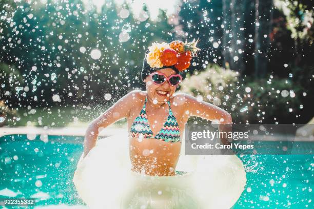 funny summer splash - kid jumping into swimming pool stock pictures, royalty-free photos & images