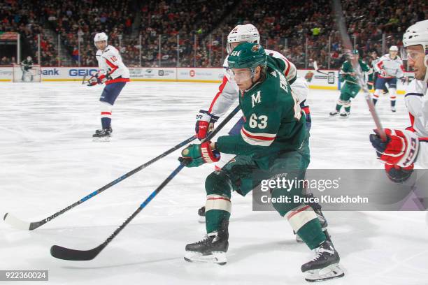 Tyler Ennis of the Minnesota Wild and Brooks Orpik of the Washington Capitals skate to the puck during the game at the Xcel Energy Center on February...