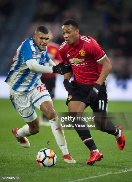 Anthony Martial of Manchester United and Collin Quaner of Huddersfield Town in action during the FA Cup Fifth Round match between Huddersfield Town...