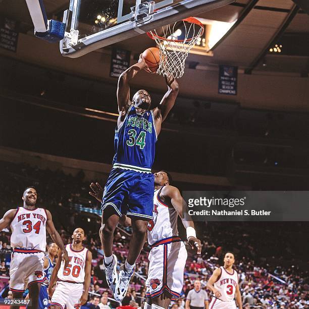 Isiah Rider of the Minnesota Timberwolves dunks against Patrick Ewing of the New York Knicks during a game played on January 17, 1994 at Madison...