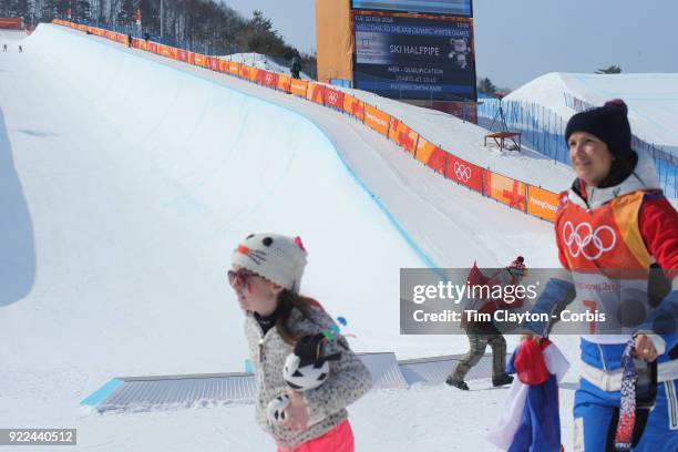 Marie Martinod of France after winning the silver medal celebrates with daughter Melirose as gold medalist Cassie Sharpe of Canada leaves the podium...