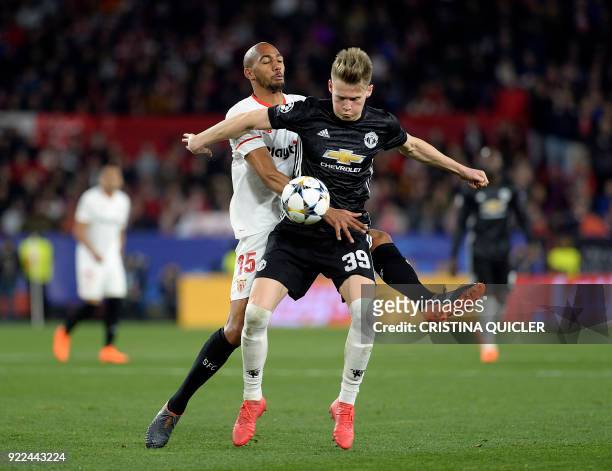 Manchester United's English midfielder Scott McTominay vies for the ball with Sevilla's French midfielder Steven N'Zonzi during the UEFA Champions...