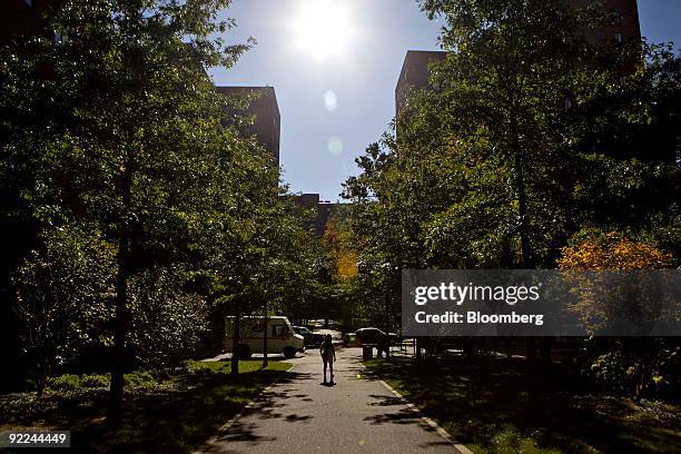 Woman walks on a sidewalk in the Stuyvesant Town-Peter Cooper Village complex in New York, U.S., on Thursday, Oct. 22, 2009. Tishman Speyer...