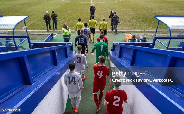 The Liverpool and Manchester United players make their way out of the Prenton Park tunnel and onto the pitch with the match officials for the start...