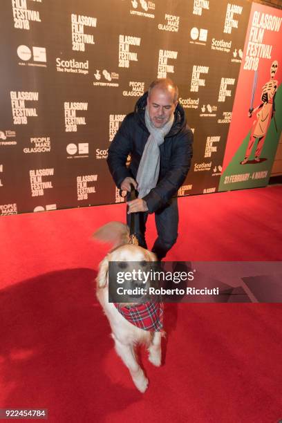 Producer Jeremy Dawson plays on the red carpet with Visit Scotland ambassador George during the UK premiere of 'Isle of Dogs' and opening gala of the...