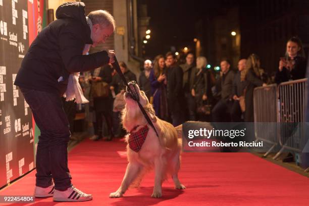 Producer Jeremy Dawson plays on the red carpet with Visit Scotland ambassador George during the UK premiere of 'Isle of Dogs' and opening gala of the...