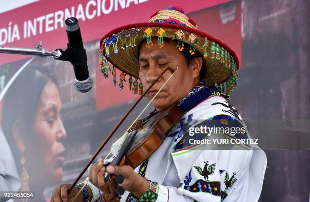 Member of the indigenous Wixarika community plays the violin during a concert presented to mark the International Day of the Mother Tongue in Mexico...