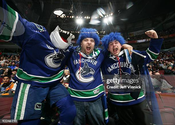 Vancouver Canucks mascot Fin celebrates with fans during the game between the Vancouver Canucks and the Minnesota Wild at General Motors Place on...