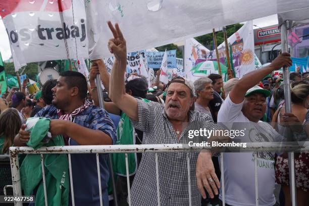 Demonstrators shout slogans and hold signs during a protest against President Mauricio Marci's economic policies in Buenos Aires, Argentina, on...