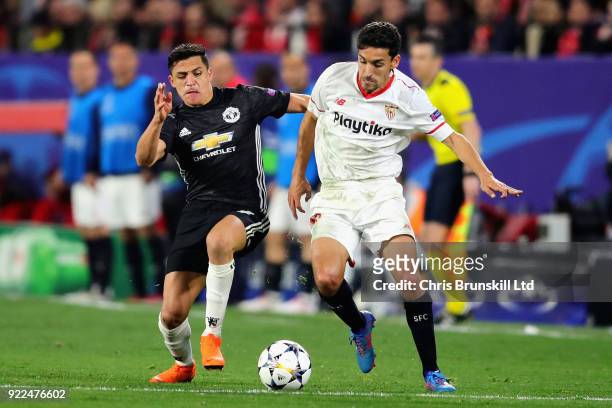 Jesus Navas of Sevilla FC is challenged by Alexis Sanchez of Manchester United during the UEFA Champions League Round of 16 First Leg match between...