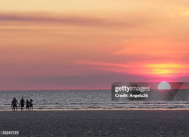 sunset on beach with pink sky - darwin australia stock pictures, royalty-free photos & images