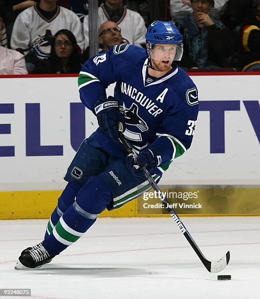 Henrik Sedin of the Vancouver Canucks skates up ice with the puck during their game against the Minnesota Wild at General Motors Place on October 17,...