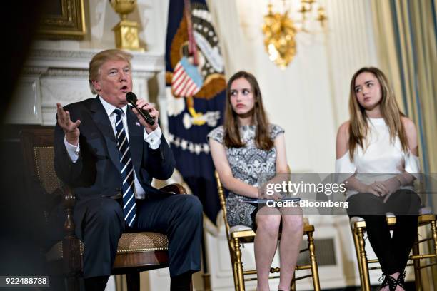 President Donald Trump, left, speaks as Carson Abt, center, and Ariana Klein, students from Marjory Stoneman Douglas High School, participate in a...