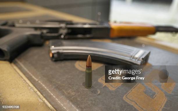 62X39mm round sits next a a 30 round magazine and an AK-47 with a bump stock installed at Good Guys Gun and Range on February 21, 2018 in Orem, Utah....