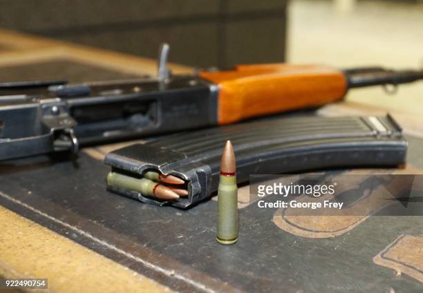 62X39mm round sits next a a 30 round magazine and an AK-47 at Good Guys Gun and Range on February 21, 2018 in Orem, Utah. The bump stock is a device...