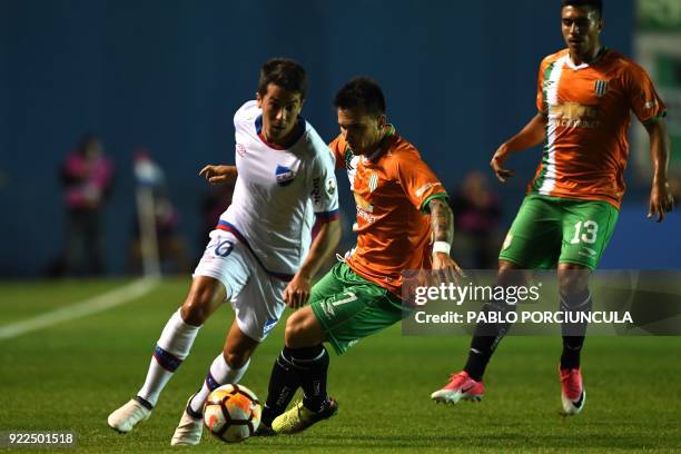 Argentina's Banfield forward Pablo Mouche vies for the ball with Uruguay's nacional midfielder Carlos de Pena during their Copa Libertadores 2018 3rd...