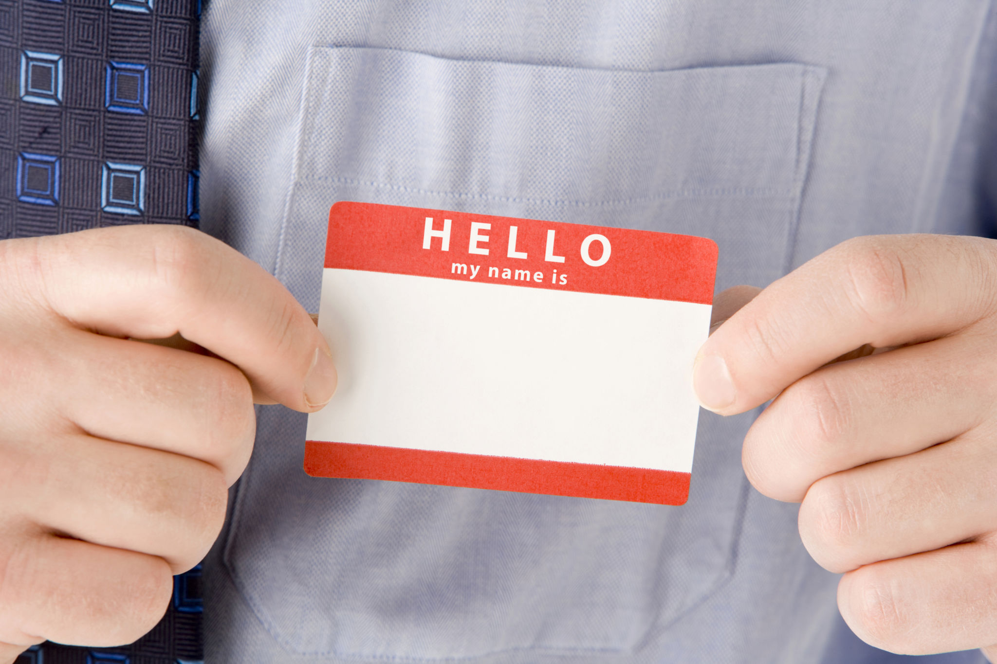 Close Up Of Businessman Attaching Name Tag Close Up Of Businessman Attaching Name Tag